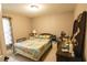 Inviting bedroom featuring a decorative bedspread, bedside table and lamps, and ample natural light at 3661 Se 131St Pl, Belleview, FL 34420