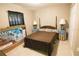 Serene bedroom with classic furniture, soft lighting, and a comfortable bed, creating a relaxing ambiance at 3661 Se 131St Pl, Belleview, FL 34420