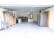 Organized garage with ample storage space, stainless steel refrigerator, and work area at 3661 Se 131St Pl, Belleview, FL 34420