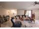 Inviting living room with comfortable seating, bright windows, and a ceiling fan at 3661 Se 131St Pl, Belleview, FL 34420