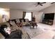 Well-lit living room with tile flooring, vaulted ceiling, and comfortable furniture at 3661 Se 131St Pl, Belleview, FL 34420