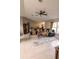 Bright and airy living room featuring tile flooring, ceiling fan, and large windows at 3661 Se 131St Pl, Belleview, FL 34420