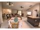 Open-concept living space combines living, dining, and kitchen areas with tile flooring and natural light at 3661 Se 131St Pl, Belleview, FL 34420