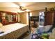 Bedroom boasts ample space with a large bed, ceiling fan, and walk-in closet for convenient storage at 3661 Se 131St Pl, Belleview, FL 34420