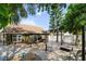 Expansive backyard patio featuring a pergola-covered dining area, stone fire pit, and lush landscaping at 3738 Crossing Creek Blvd, St Cloud, FL 34772