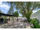 Spacious backyard featuring a paved patio, mature trees, and a white fence for added privacy at 3738 Crossing Creek Blvd, St Cloud, FL 34772