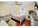 Bright bedroom featuring hardwood floors, a ceiling fan, and a cozy bed, perfect for a restful night's sleep at 3738 Crossing Creek Blvd, St Cloud, FL 34772