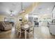 Open-concept living space featuring a large dining table with modern lighting and neutral color palette at 3738 Crossing Creek Blvd, St Cloud, FL 34772