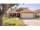 Charming single Gathering home with an attached two-car garage and beautifully landscaped front yard at 3738 Crossing Creek Blvd, St Cloud, FL 34772