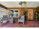 Inviting front porch with tile flooring and rocking chairs, perfect for relaxing outdoors at 3738 Crossing Creek Blvd, St Cloud, FL 34772