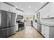 Well-lit kitchen boasting stainless steel appliances, granite countertops and white cabinetry at 3738 Crossing Creek Blvd, St Cloud, FL 34772