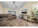 Comfortable living room with plush seating, entertainment center, and sliding glass doors at 3738 Crossing Creek Blvd, St Cloud, FL 34772