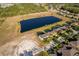 Aerial view of home with pond and backyard with proximity to neighborhood at 389 Yellow Snapdragon Dr, Davenport, FL 33837
