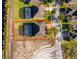 Aerial view of property backing up to a pond, featuring an enclosed screened pool at 389 Yellow Snapdragon Dr, Davenport, FL 33837