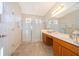 Bathroom featuring a walk-in shower, dual vanities, and ample lighting for a luxurious experience at 389 Yellow Snapdragon Dr, Davenport, FL 33837