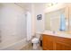 Bright bathroom features a shower and bathtub combination with a wood vanity at 389 Yellow Snapdragon Dr, Davenport, FL 33837