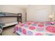 Cozy bedroom featuring bunk beds, colorful bedding, and neutral walls at 389 Yellow Snapdragon Dr, Davenport, FL 33837