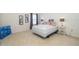 Comfortable bedroom with neutral carpet, large windows, and decorative artwork at 389 Yellow Snapdragon Dr, Davenport, FL 33837
