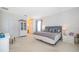 Large primary bedroom with plush carpeting, neutral walls, and a stylish en-suite bathroom at 389 Yellow Snapdragon Dr, Davenport, FL 33837