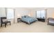 Well-lit bedroom with neutral carpet, large windows, and a comfortable blue bed at 389 Yellow Snapdragon Dr, Davenport, FL 33837
