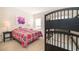 Cozy bedroom with colorful bedding, bunk beds, and a bright window at 389 Yellow Snapdragon Dr, Davenport, FL 33837