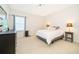Bright bedroom features neutral carpet, large windows, and a comfortable bed at 389 Yellow Snapdragon Dr, Davenport, FL 33837