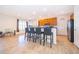 Open kitchen with breakfast bar, wooden cabinetry, stainless steel appliances, and tile flooring at 389 Yellow Snapdragon Dr, Davenport, FL 33837