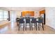 Bright kitchen featuring a breakfast bar, tile flooring, wooden cabinets, and stainless steel appliances at 389 Yellow Snapdragon Dr, Davenport, FL 33837