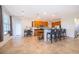 Well-lit kitchen with breakfast bar, wooden cabinets, stainless appliances, and tile flooring extending into the living space at 389 Yellow Snapdragon Dr, Davenport, FL 33837