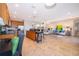 Bright, open-concept living room with tile flooring, modern furniture, and a kitchen with a breakfast bar at 389 Yellow Snapdragon Dr, Davenport, FL 33837