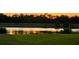 Beautiful pond view at sunset, reflecting warm colors and serene landscapes at 389 Yellow Snapdragon Dr, Davenport, FL 33837