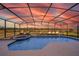 Stunning screened-in pool area with sunset views, perfect for evening relaxation and entertainment at 389 Yellow Snapdragon Dr, Davenport, FL 33837