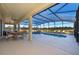 Beautiful screened-in pool area featuring a covered patio with dining and lounge spaces at 389 Yellow Snapdragon Dr, Davenport, FL 33837