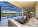 Inviting screened-in pool with covered patio, fire pit, and comfortable seating for outdoor living at 389 Yellow Snapdragon Dr, Davenport, FL 33837