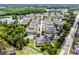 Beautiful aerial view of the multi-Gathering homes surrounded by lush green trees, pond and parking lot at 4551 Jonafree Ln # 103, Kissimmee, FL 34746
