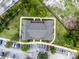 Top-down drone shot of complex surrounded by trees, lawns, and a parking area at 4551 Jonafree Ln # 103, Kissimmee, FL 34746