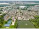Extensive aerial showcases a community with diverse amenities, including a lake, pool, sports courts, and attractive townhomes at 4551 Jonafree Ln # 103, Kissimmee, FL 34746