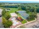 Aerial view showcases community amenities, including a lake, splash pad, playground, volleyball, tennis, and basketball courts at 4551 Jonafree Ln # 103, Kissimmee, FL 34746