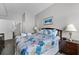 Cozy bedroom featuring coastal decor, a plush bed, and en-suite bathroom entrance at 4551 Jonafree Ln # 103, Kissimmee, FL 34746