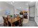 Dining area with wooden table and view to the kitchen, stairwell, and carpeted floors at 4551 Jonafree Ln # 103, Kissimmee, FL 34746