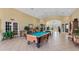 Bright game room with large windows and doors, tile floors, pool table, foosball and air hockey at 4551 Jonafree Ln # 103, Kissimmee, FL 34746