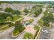 Aerial shot of the community gate with lush landscaping, a guard house, and colorful townhomes in the background at 4551 Jonafree Ln # 103, Kissimmee, FL 34746