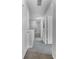 Bright hallway with carpeted floors, white doors, and neutral paint at 4551 Jonafree Ln # 103, Kissimmee, FL 34746