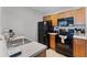 The kitchen features wood cabinets, black appliances, and tile flooring at 4551 Jonafree Ln # 103, Kissimmee, FL 34746