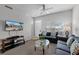 Living room features a sofa set, ceiling fan, tile foyer, and a large window at 4551 Jonafree Ln # 103, Kissimmee, FL 34746