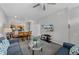 Comfortable living room with grey walls, ceiling fan, dining area, kitchen, and carpeted floors at 4551 Jonafree Ln # 103, Kissimmee, FL 34746