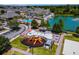 Aerial view of a community playground and splash pad, with colorful equipment and a lake in the background at 4551 Jonafree Ln # 103, Kissimmee, FL 34746