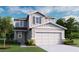 Charming two-story home with a two-car garage, landscaped front yard, and neutral color palette at 5224 Bee Balm St, Lake Hamilton, FL 33851