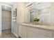 Bathroom featuring a double vanity with white cabinetry, a large mirror, and a glass-enclosed shower at 5228 Bee Balm St, Lake Hamilton, FL 33851
