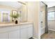 Bathroom featuring a double vanity with white cabinetry, a large mirror, and a bathtub with a shower at 5228 Bee Balm St, Lake Hamilton, FL 33851